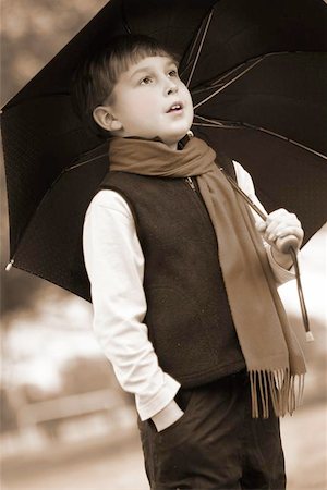rosy cheeks - Little boy sheltering himself from the rain,     Focus to face, f1.8 Stock Photo - Budget Royalty-Free & Subscription, Code: 400-06130636
