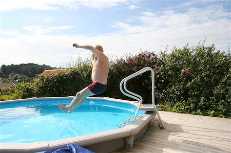 senior man jumping into pool - This is actually my dad jumping in our swimming pool at home Stock Photo - Budget Royalty-Free & Subscription, Code: 400-06131666