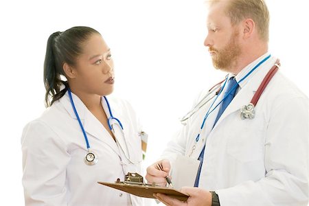 Teamwork.  A male and female doctor in discussion.  Focus on man Stock Photo - Budget Royalty-Free & Subscription, Code: 400-06131746