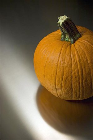simsearch:400-04008520,k - Orange pumpkin sitting on a stainless steel surface. Stock Photo - Budget Royalty-Free & Subscription, Code: 400-06131929