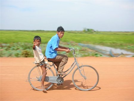 Father and Son on bike in Cambodia Stock Photo - Budget Royalty-Free & Subscription, Code: 400-06132243