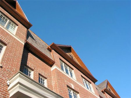 dormir - New brick townhomes on the background of bright blue sky Stock Photo - Budget Royalty-Free & Subscription, Code: 400-06132551