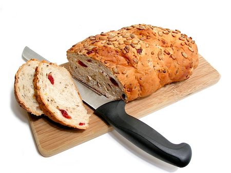 Artisan pumkin seed and cranberry bread on a cutting board with a bread knife, white background Foto de stock - Super Valor sin royalties y Suscripción, Código: 400-06133016