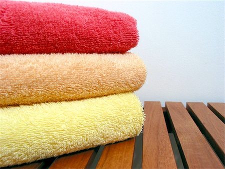 simsearch:400-06133108,k - Stack of bright colorful clean towels on a wooden bench Stock Photo - Budget Royalty-Free & Subscription, Code: 400-06133219