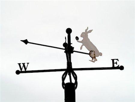 A metal weathervane in Llandudno, North Wales. The white rabbit  makes reference to the town's historical connection  to 'Alice in Wonderland'. Fotografie stock - Microstock e Abbonamento, Codice: 400-06133221