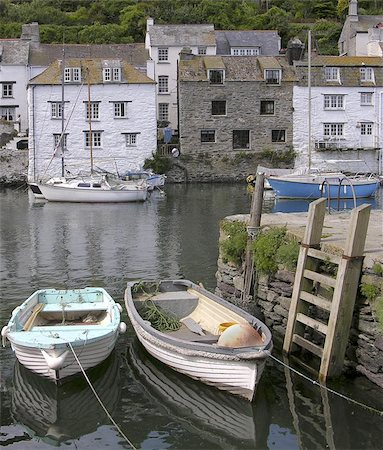 polperro - This image was taken in the Harbour at Polperro in Cornwall showing the local rowing boats and other moored boats with a backdrop of typical cornish Stone built houses reaching down to the harbour. Stock Photo - Budget Royalty-Free & Subscription, Code: 400-06133490