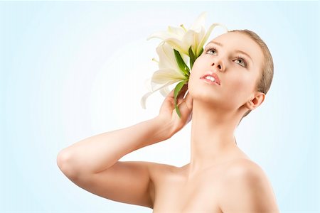 smelling hair - beauty portait of pretty young girl with lilies, she looks up and takes lilies near the right ear Stock Photo - Budget Royalty-Free & Subscription, Code: 400-06140207