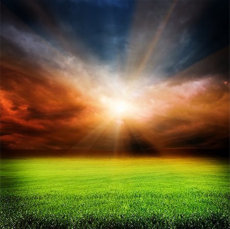 simsearch:400-07932789,k - stormy evening clouds in the sky and green field of grass with sun light passing through Stock Photo - Budget Royalty-Free & Subscription, Code: 400-06140370