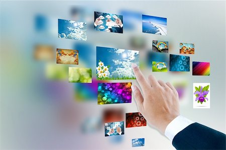 men hand using touch screen interface with pictures in frames Stock Photo - Budget Royalty-Free & Subscription, Code: 400-06140501