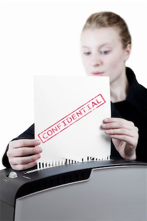 woman shredding a confidential paper Fotografie stock - Microstock e Abbonamento, Codice: 400-06140561