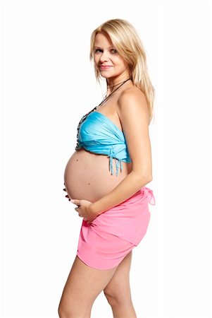 Woman holding her pregnant belly. 9 month. Studio photo of pregnant woman isolated on white. Stock Photo - Budget Royalty-Free & Subscription, Code: 400-06140884