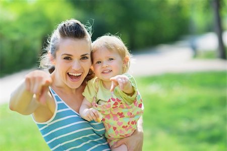 Happy mother and baby pointing in camera Stock Photo - Budget Royalty-Free & Subscription, Code: 400-06141131