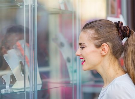 Curious girl looking on showcase Stock Photo - Budget Royalty-Free & Subscription, Code: 400-06141181