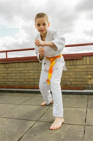 judoka teen boy training judo on the sky background Stock Photo - Budget Royalty-Free & Subscription, Code: 400-06141671