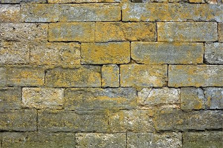 simsearch:400-05361674,k - Ancient stone wall with large blocks partially covered with green lichen Fotografie stock - Microstock e Abbonamento, Codice: 400-06141994