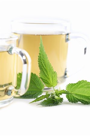simsearch:400-04691031,k - Nettle and freshly made nettle tea in glass cups isolated on white background. Shallow dof, focus on nettle Photographie de stock - Aubaine LD & Abonnement, Code: 400-06142046