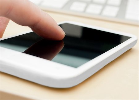 simsearch:400-04412834,k - Closeup of Man's Hand Touching Screen of White Modern Smartphone - Shallow Depth of Field Stock Photo - Budget Royalty-Free & Subscription, Code: 400-06142332