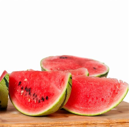simsearch:400-05886533,k - fresh ripe watermelon sliced on a  wood table over white background Photographie de stock - Aubaine LD & Abonnement, Code: 400-06142444