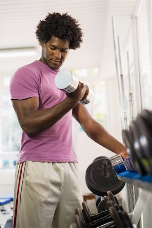 Sport and fun, young african american male athlete taking weights from shelf in fitness club Stock Photo - Budget Royalty-Free & Subscription, Code: 400-06142506