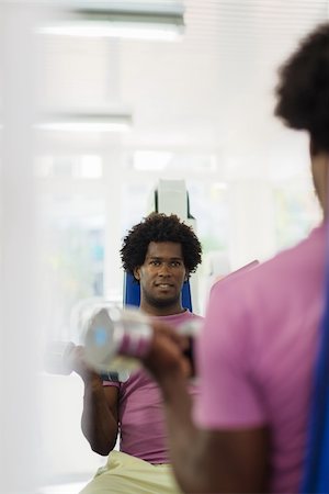 Sports activity, young african man exercising and working out in fitness gym. Copy space Stock Photo - Budget Royalty-Free & Subscription, Code: 400-06142509