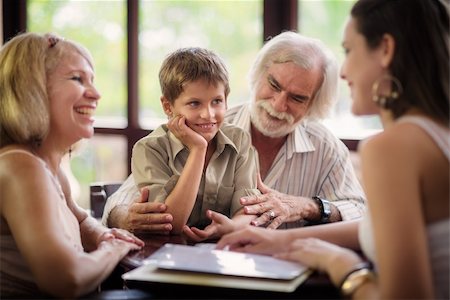family dining restaurant - Happy family with husband, wife, child, grandfather and grandmother choosing food and drinks in bar Stock Photo - Budget Royalty-Free & Subscription, Code: 400-06143276