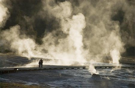 People silhouetted against mist from Grand Prismatic Hot Spring in Yellowstone National Park, Wyoming Photographie de stock - Aubaine LD & Abonnement, Code: 400-06143497
