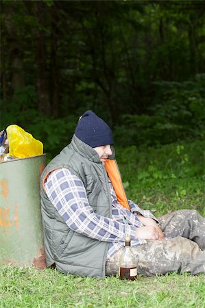 Homeless leaning against the garbage bins Foto de stock - Royalty-Free Super Valor e Assinatura, Número: 400-06174116