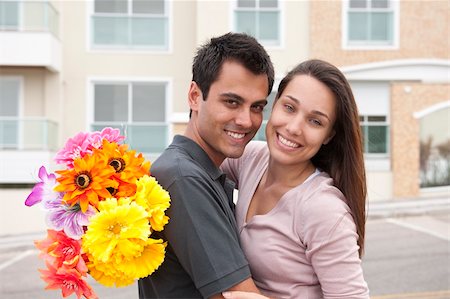 Hispanic man surprising his girlfriend with a bouquet Stock Photo - Budget Royalty-Free & Subscription, Code: 400-06174263