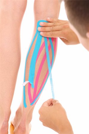 A picture of a special physio tape put on an injured calf over white background Foto de stock - Super Valor sin royalties y Suscripción, Código: 400-06174477