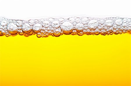 close up shot of yellow beer with foam and bubbles  on white background Stock Photo - Budget Royalty-Free & Subscription, Code: 400-06174538