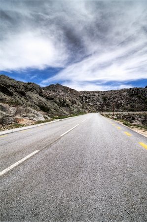 simsearch:400-07524978,k - Asphalt road in the mountains and blue sky with clouds. Photographie de stock - Aubaine LD & Abonnement, Code: 400-06174777