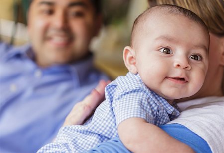 Happy Attractive Mixed Race Couple Burping Thier Smiling Son. Stock Photo - Budget Royalty-Free & Subscription, Code: 400-06174934