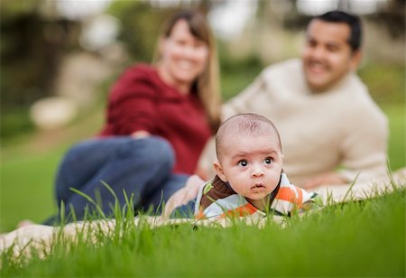 Happy Mixed Race Baby Boy and Parents Playing Outdoors in the Park. Stock Photo - Budget Royalty-Free & Subscription, Code: 400-06174945