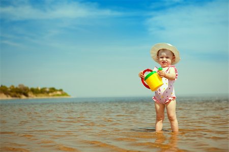 simsearch:400-04596901,k - small girl with watering-pot on the seashore Stock Photo - Budget Royalty-Free & Subscription, Code: 400-06175006