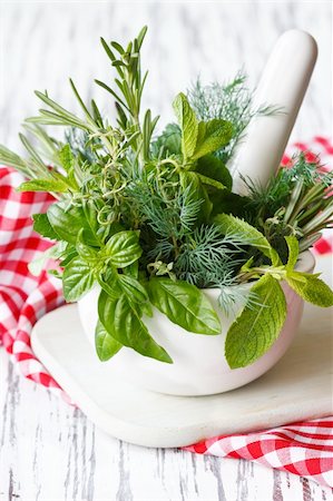 Spicy herbs in white ceramic mortar and pestle. Stockbilder - Microstock & Abonnement, Bildnummer: 400-06175102
