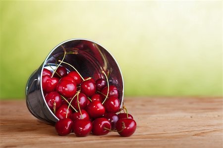Cherries in a bucket on old wooden table - summer fruits Stock Photo - Budget Royalty-Free & Subscription, Code: 400-06175359