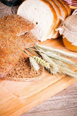 sliced bread and wheat on the wooden table Stock Photo - Budget Royalty-Free & Subscription, Code: 400-06175535