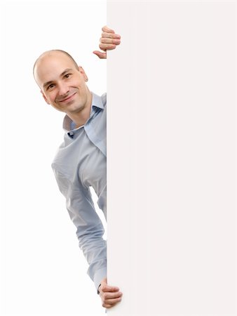 smiling handsome man posing behind a billboard Stock Photo - Budget Royalty-Free & Subscription, Code: 400-06175656