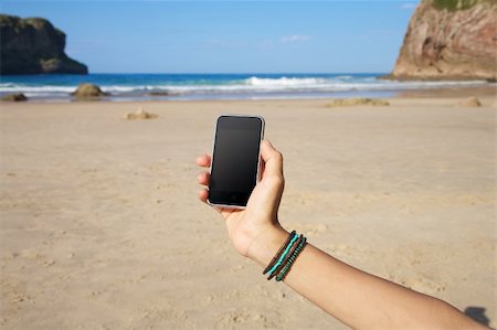 simsearch:400-05918503,k - smart phone in woman hand on a beach in Asturias Spain Photographie de stock - Aubaine LD & Abonnement, Code: 400-06175723