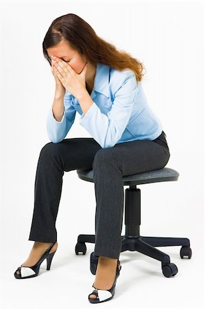 Stress. Woman hides her face in her hands while sitting on an office chair Stock Photo - Budget Royalty-Free & Subscription, Code: 400-06176279