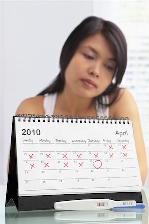 sad young and pregnant - Sad woman with negative pregnancy test and calendar. A concept being failed to get pregnant Stock Photo - Budget Royalty-Free & Subscription, Code: 400-06176378