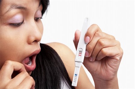 pregnant surprise - Asian lady holding pregnancy test device Stock Photo - Budget Royalty-Free & Subscription, Code: 400-06176389