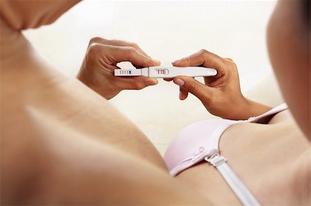 Couple looking at positive pregnancy test together Stock Photo - Budget Royalty-Free & Subscription, Code: 400-06176382