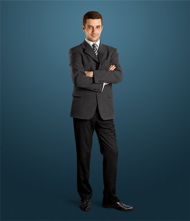 fashionable office worker full length - business man in suit full-length, looking on camera, with folded hands Stock Photo - Budget Royalty-Free & Subscription, Code: 400-06176822