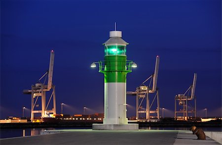 Late night at the port of Aarhus in Denmark with a lighthouse and cranes in the background Stock Photo - Budget Royalty-Free & Subscription, Code: 400-06177076