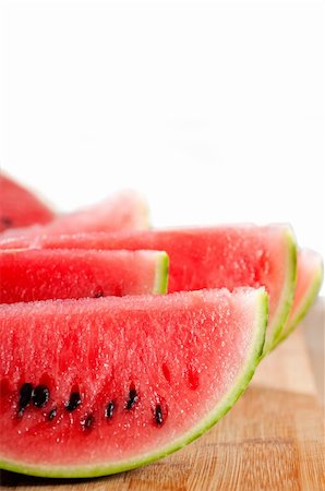 fresh ripe watermelon sliced on a  wood table over white background Photographie de stock - Aubaine LD & Abonnement, Code: 400-06177767