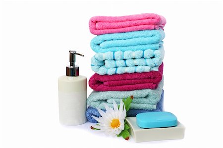 simsearch:400-06564793,k - Stack of towels, soaps and flowers isolated on white background. Photographie de stock - Aubaine LD & Abonnement, Code: 400-06177961