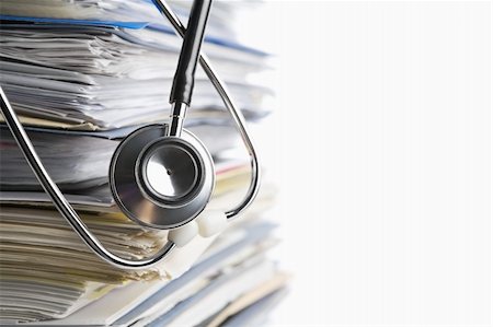 Medical record concept with stetoschope over pile of document. Selective focus on the front side of the stethoscope Photographie de stock - Aubaine LD & Abonnement, Code: 400-06177984