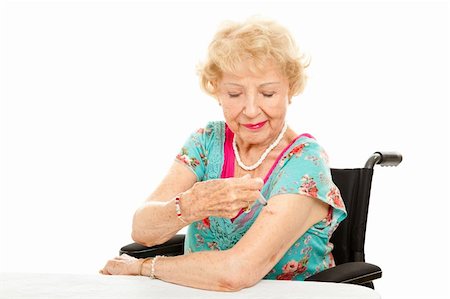Senior woman in a wheelchair, giving herself an injection.  White background. Stock Photo - Budget Royalty-Free & Subscription, Code: 400-06178219