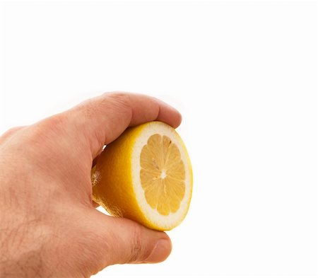 simsearch:400-08814206,k - fresh ripe lemon cutted in half hold in hand closedup Photographie de stock - Aubaine LD & Abonnement, Code: 400-06178578
